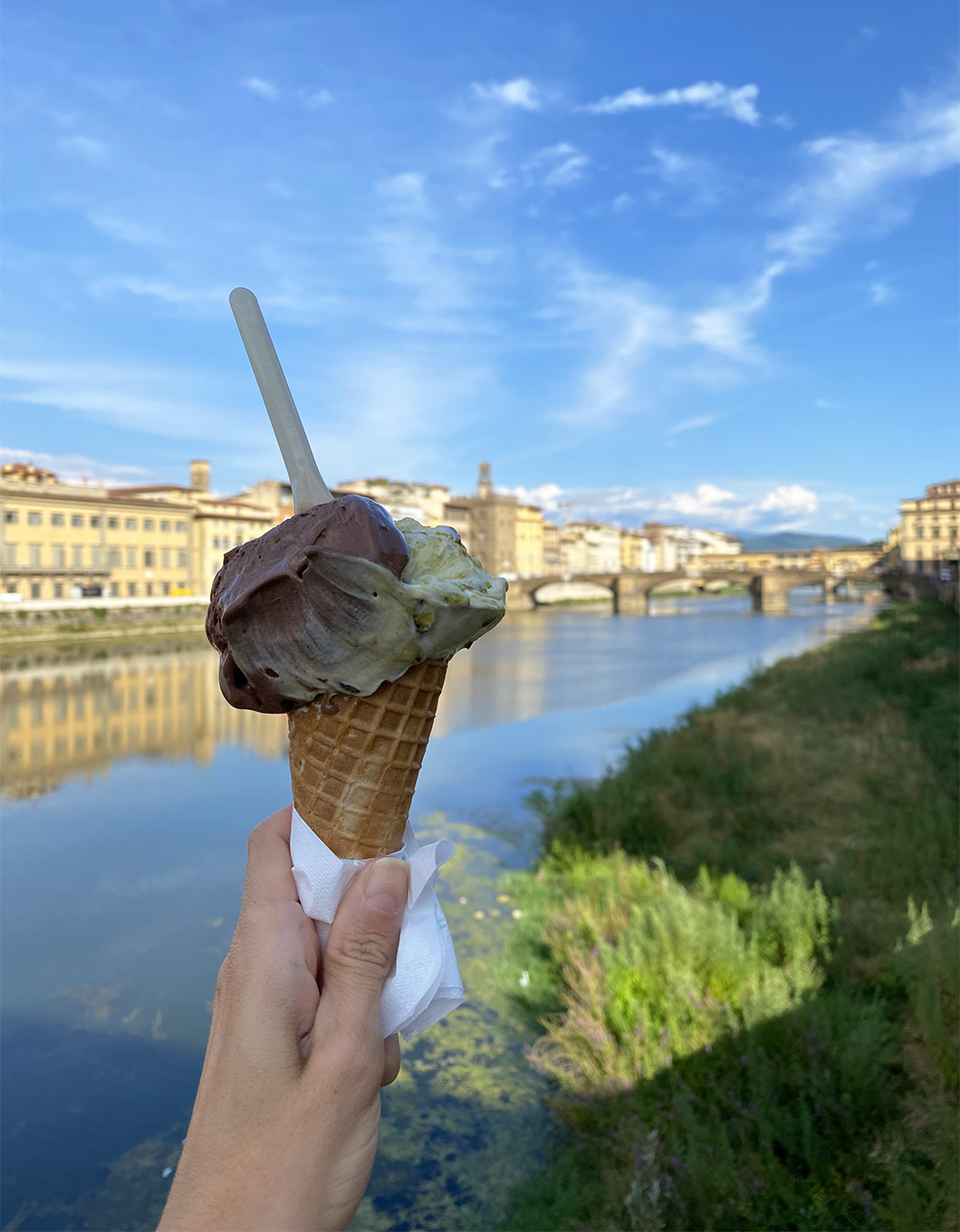 A scoop of gelato on the bridge Ponte alla Carraia in Florence
