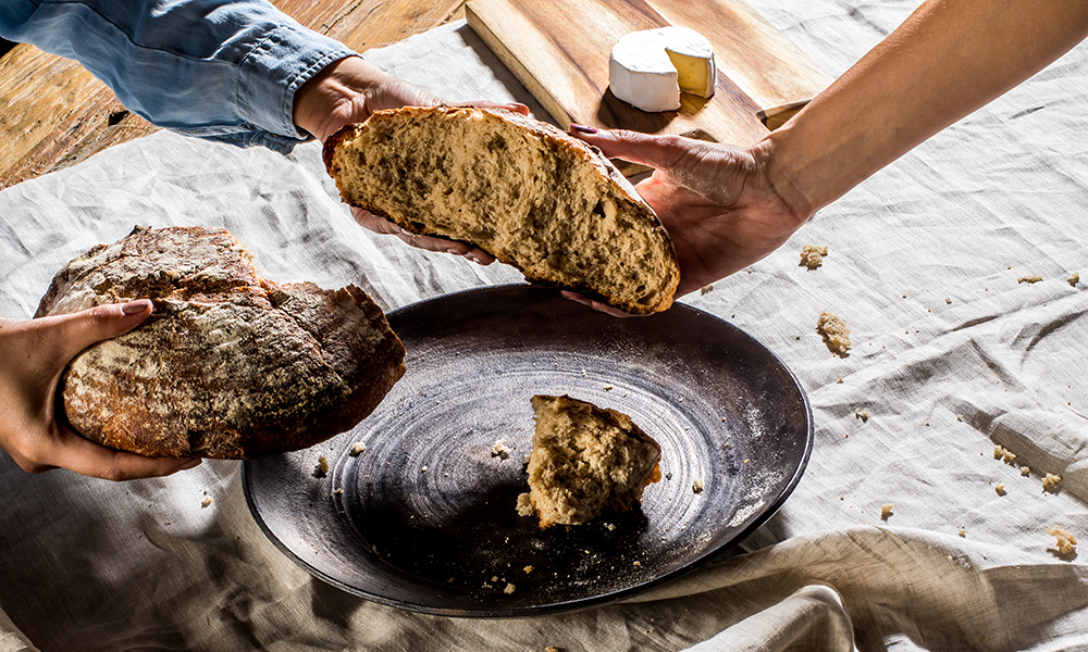 Friends sharing a freshly baked artisanal bread
