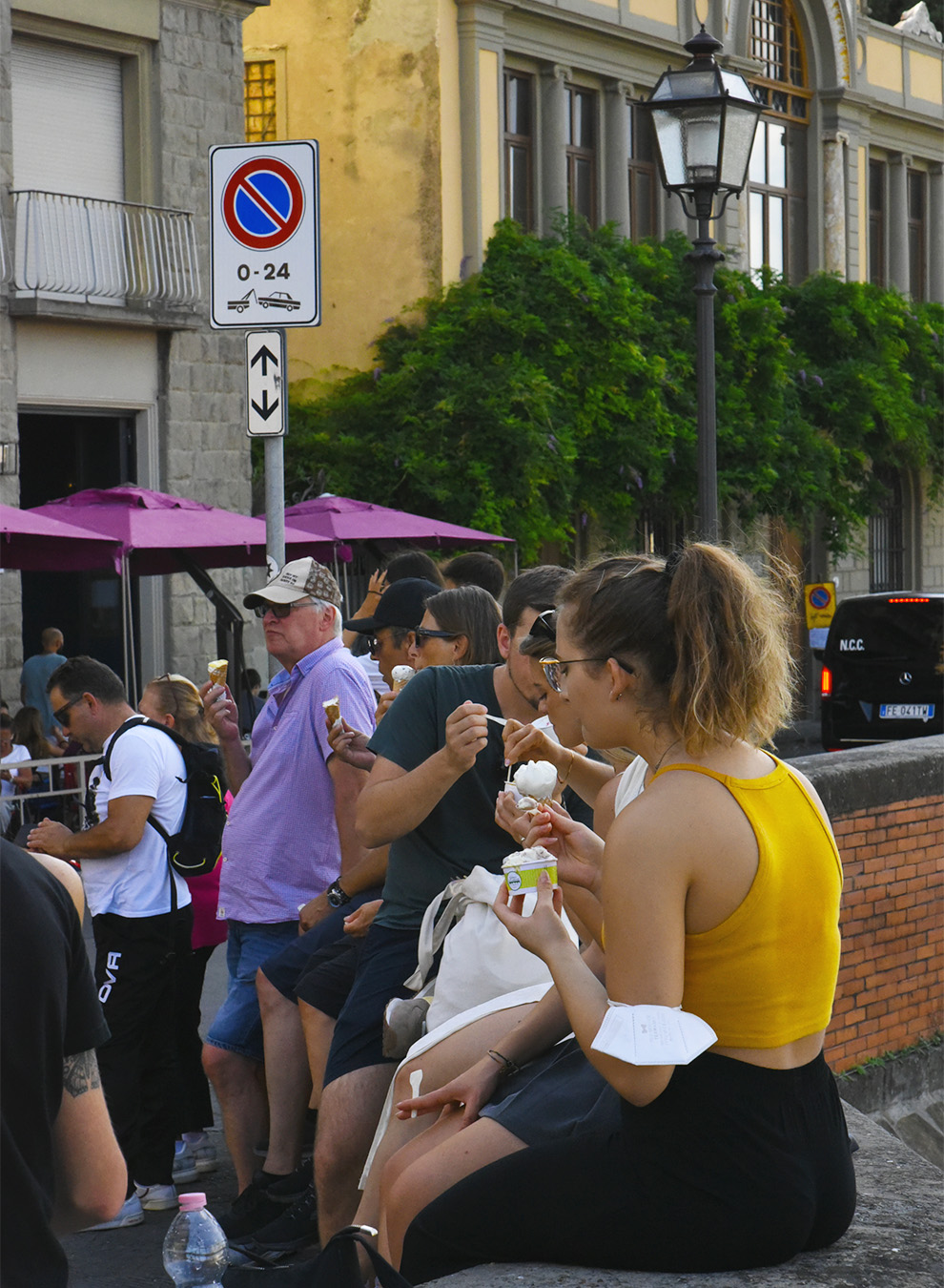 Tourists having gelato in the corner of the gelataria La Carraia in Florence 