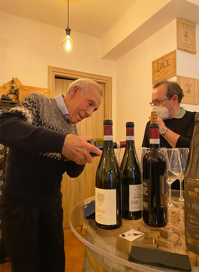 Sr. Murgia pouring wine at his enoteca Vini e Delizie in Florence